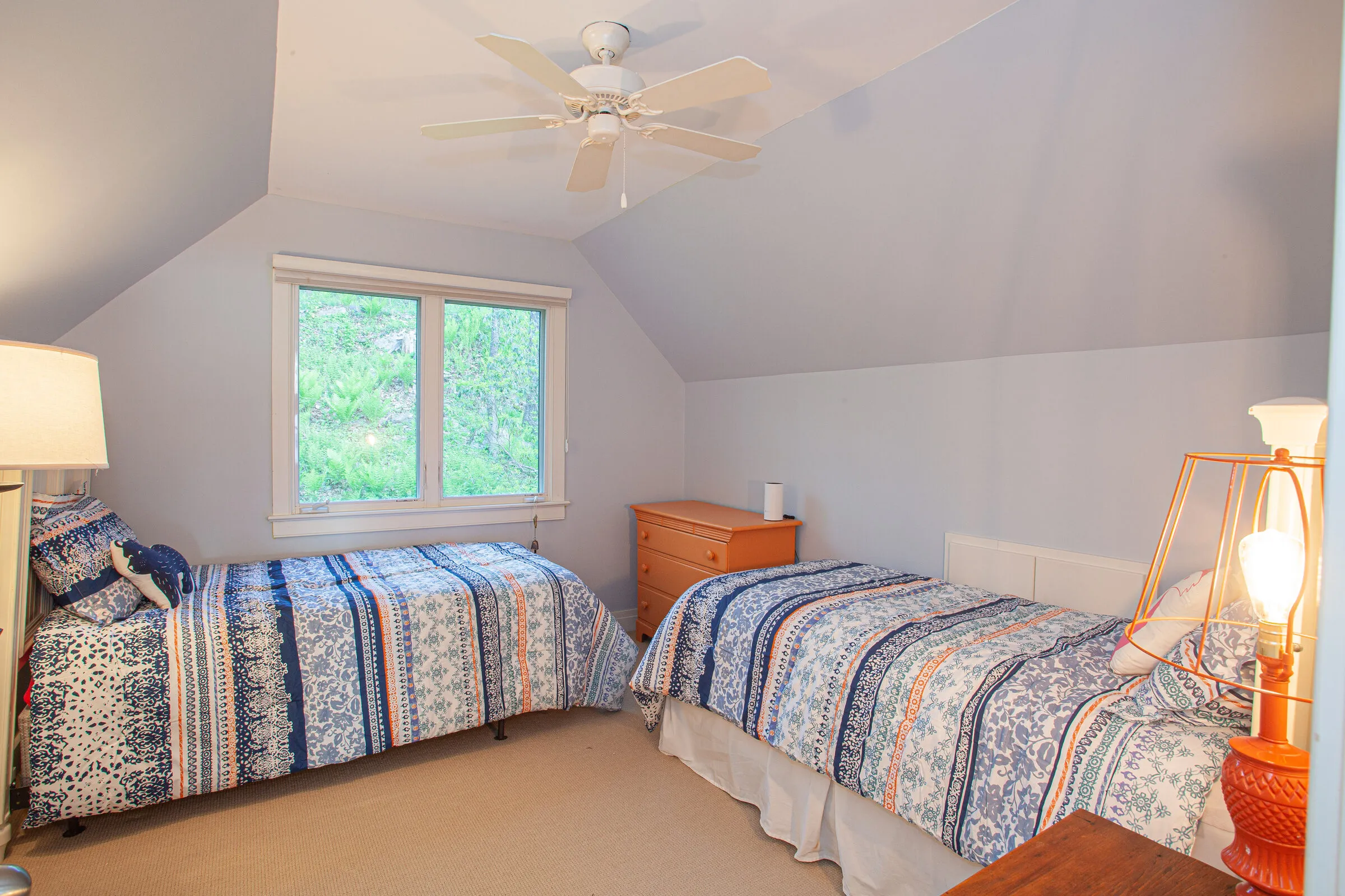 Bedroom with two twin beds under a vaulted ceiling